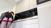 Hot sexy long legs brunette wife in black and red fishnet stockings with a satin nightie teases in the kitchen
