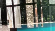 My neighbors are taking a shower on the patio. I must go there to see it up close