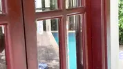 My neighbors are taking a shower on the patio. I must go there to see it up close