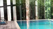 My neighbors are taking a shower on the patio. I must go there to see it up close