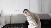 Amazingly beautiful petite blonde hot college girl in her dormitory kitchen getting ready for Christmas Party