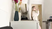 Amazingly beautiful petite blonde hot college girl in her dormitory kitchen getting ready for Christmas Party