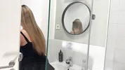 Amazingly beautiful college girl in the bathroom with a super skirt miniskirt shows her ass