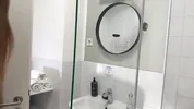 Amazingly beautiful college girl in the bathroom with a super skirt miniskirt shows her ass