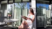 Wonderfully beautiful girl in a summer dress no panties on the balcony shows her tight shaved pussy to the neighbors