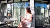 Wonderfully beautiful girl in a summer dress no panties on the balcony shows her tight shaved pussy to the neighbors