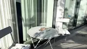 Wonderfully beautiful girl in a summer dress no panties on the balcony shows her tight shaved pussy to the neighbors