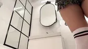 Big boobs hot blonde in a cut modified short mini skirt in the bathroom shows her big tits and legs