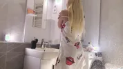 Sexy beauty cute blonde horny girl in pink panties and with a satin nightie does the bathroom routine before going to the bed