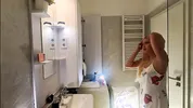 Sexy beauty cute blonde horny girl in pink panties and with a satin nightie does the bathroom routine before going to the bed