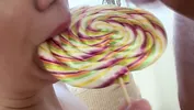 The couple is having very romantic sex; she licks a lollipop and then his balls.