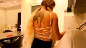Hot tattooed blonde long hair beauty in the kitchen takes her panties off to show her meaty pussy an