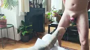 A sex slave in a cock cage has his balls whipped by a dominatrix while, right before her eyes, he sucks his Master's cock until he cums on him.