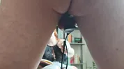 A sex slave in a cock cage has his balls whipped by a dominatrix while, right before her eyes, he sucks his Master's cock until he cums on him.