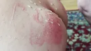 A sex slave in a cock cage has his balls whipped by a dominatrix while, right before her eyes, he sucks his Master's cock until he cums on him.