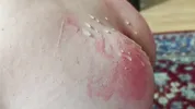 A sex slave in a cock cage has his balls whipped by a dominatrix while, right before her eyes, he sucks his Master's cock until he cums on him.