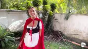 Little Red Riding Hood lost a fruit from her basket and is looking for it in the wolf's pants.