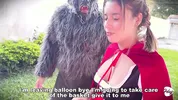 Little Red Riding Hood lost a fruit from her basket and is looking for it in the wolf's pants.