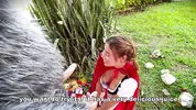 Little Red Riding Hood lost a fruit from her basket and is looking for it in the wolf's pants.